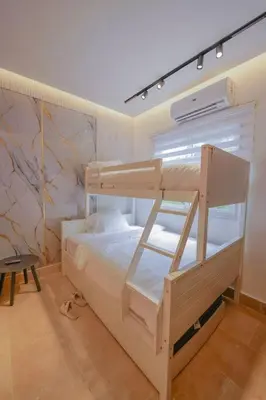 a bedroom with two bunk beds in a room at Villa Hermosa en Metro Country Club Juan Dolio in Juan Dolio
