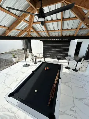 a ping pong table sitting on a patio at LEVEL suites #8 in Sosúa