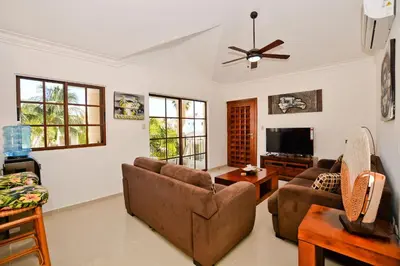 a living room with a couch and a tv at Rosa Hermosa Penthouse | Vista Piscina • Bávaro in Punta Cana