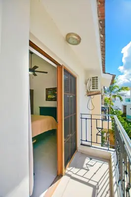 a balcony with a room with a bed and a window at Rosa Hermosa Penthouse | Vista Piscina • Bávaro in Punta Cana