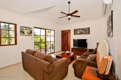 a living room with two couches and a tv at Rosa Hermosa Penthouse | Vista Piscina • Bávaro in Punta Cana