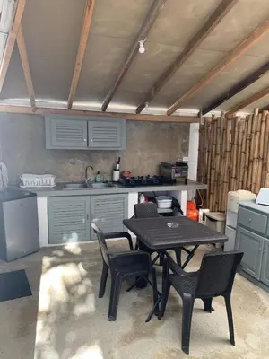 a kitchen with a table and chairs in a room at La casita del sol in Las Terrenas