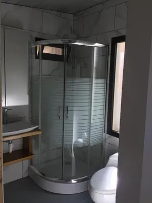 a bathroom with a glass shower with a toilet at La casita del sol in Las Terrenas