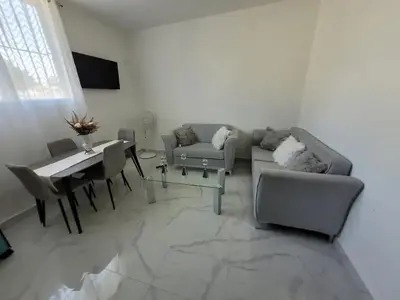 a living room with a couch and a table at Close in Santo Domingo