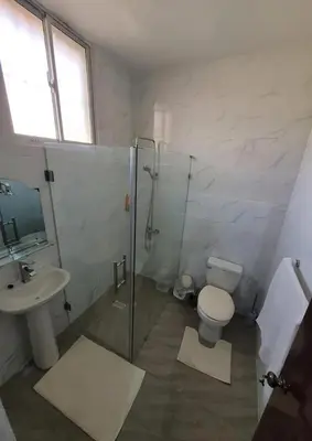 a bathroom with a shower and a toilet and a sink at Close in Santo Domingo