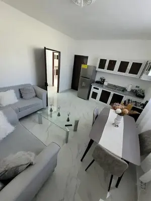 a living room with a couch and a table at Close in Santo Domingo