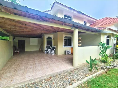 a patio of a house with a wooden pergola at Linkzup Playa Laguna Villa in Sosúa