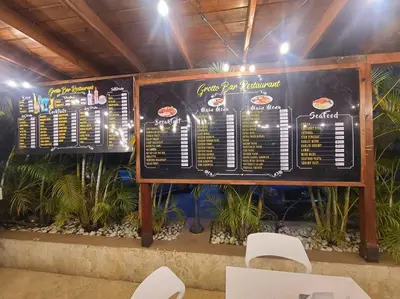 a menu for a fast food restaurant with white chairs at Linkzup Playa Laguna Villa in Sosúa