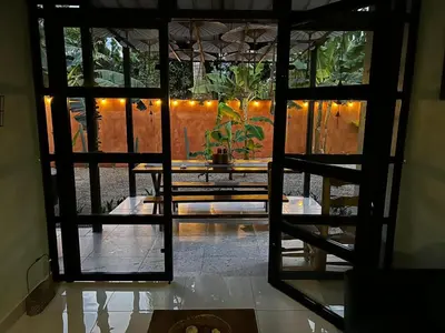 an open door to a patio with a table at Casa Monte Verde in Las Galeras