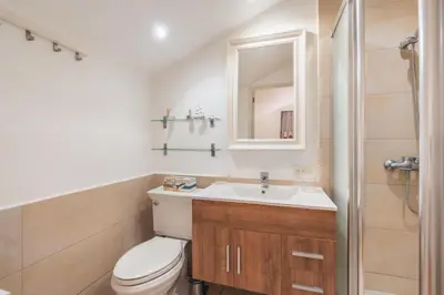 a bathroom with a toilet and a sink and a mirror at Unique gem penthouse in playa bonita in Las Terrenas