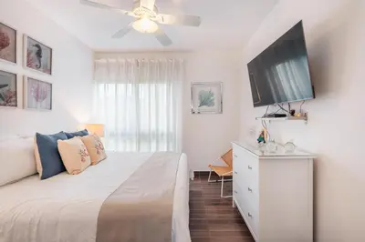 a bedroom with a bed and a flat screen tv at Unique gem penthouse in playa bonita in Las Terrenas