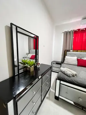 a bedroom with a dresser with a mirror and a bed at Villa Angel in San Felipe de Puerto Plata