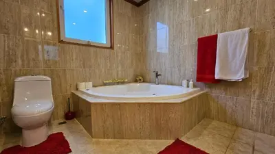 a bathroom with a tub and a toilet and a sink at Hispaniola Beach Retreat in Sosúa