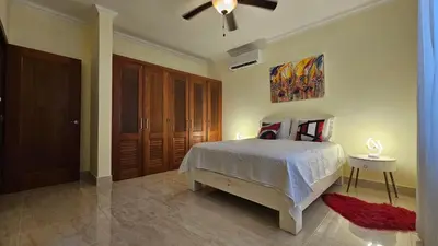 a bedroom with a bed and a ceiling fan at Hispaniola Beach Retreat in Sosúa