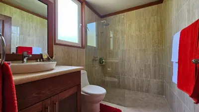 a bathroom with a toilet and a sink and a shower at Hispaniola Beach Retreat in Sosúa