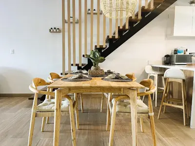 a dining room with a wooden table and chairs at Exclusivo penthouse con piscina en Playa Bávaro in Punta Cana