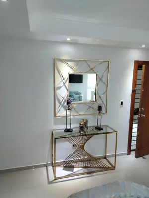 a mirror and a console table in a room at El apartamento que tu necesita para disfrutar tu vacaciones in Villa Mella
