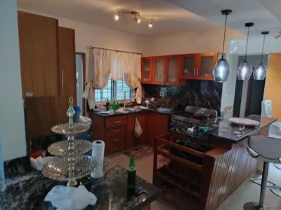 a kitchen with wooden cabinets and a counter top at El apartamento que tu necesita para disfrutar tu vacaciones in Villa Mella