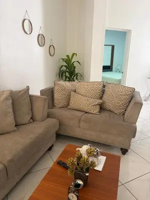 a living room with a couch and a table at Bello y acogedor Apartamento in Santiago de los Caballeros