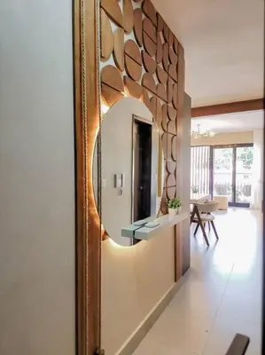 a mirror on a wall in a living room at Luxury Apartment Downtown in Santiago de los Caballeros