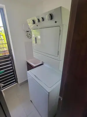 a small kitchen with a refrigerator and a stove at Luxury Apartment Downtown in Santiago de los Caballeros