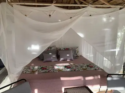 a bed in a white tent with a mosquito net at EL Cielo de Cana in Las Terrenas