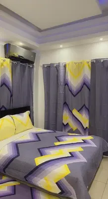 a bedroom with a bed with purple and yellow sheets at Fantástico y pequeño estudio in Santiago de los Caballeros