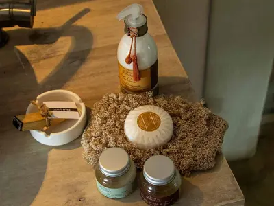 a table topped with spices and a bottle of sauce at JandalaVillage in Las Terrenas