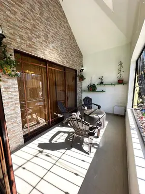 a patio with chairs and a table and a brick wall at Cerca del divino niño I WiFi I TV in Constanza