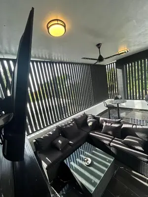 a living room with a black couch and a table at Level suites Penthouse in Sosúa