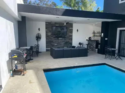 a patio with a pool and a table and chairs at Level suites Penthouse in Sosúa