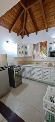 a large kitchen with white cabinets and a stove at Chalet tropical au cœur de Las Terrenas in Las Terrenas