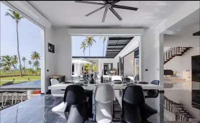 a dining room with a table and chairs at Casa black and white frente al mar in Las Galeras