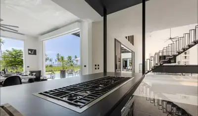 a kitchen with a stove top oven in a room at Casa black and white frente al mar in Las Galeras