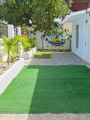 a yard of green grass in front of a house at Villa el real los patos in Los Patos