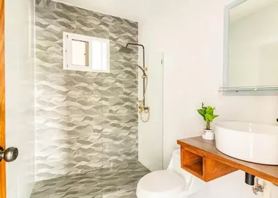 a bathroom with a toilet and a sink at Modern Vacation Paradise Villa with Private Pool in Sosúa