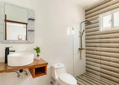 a bathroom with a sink and a toilet at Modern Vacation Paradise Villa with Private Pool in Sosúa