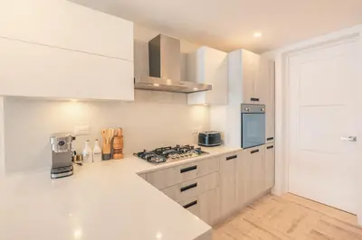 a kitchen with white cabinets and a stove top oven at Exceptional apartment nearby beach at Portillo in Las Terrenas