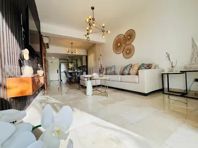 a living room with a couch and a table at Paradise Pool Front and Beach Condo at Punta Cana in Punta Cana