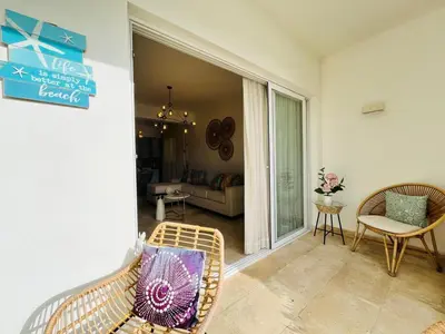 a living room with a couch and a chair at Paradise Pool Front and Beach Condo at Punta Cana in Punta Cana