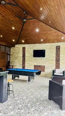 a blue ping pong table in a room with a tv at Río Privado Villa Jarabacoa con Picuzzi in Jarabacoa