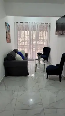 a living room with a couch and a table at Departamento Sol in Santo Domingo