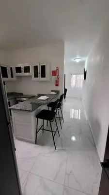 a kitchen with a table and chairs in a room at Departamento Estrella en Santo Domingo in Santo Domingo