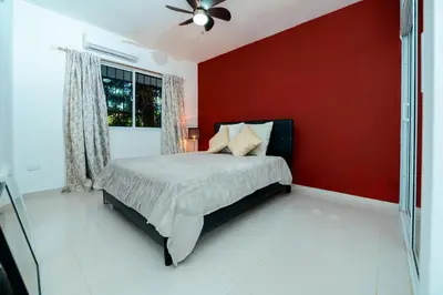 a bedroom with a red wall and a bed at Villa Campo Sosúa - Apartamento in Sosúa