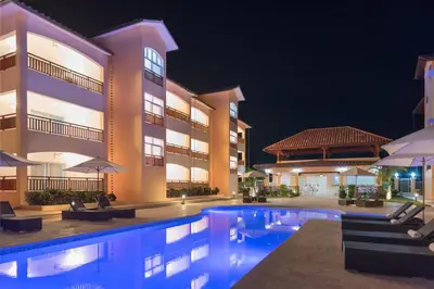 a view of a resort pool at night at Los Flamencos Aparthotel Beach Club in Bayahibe
