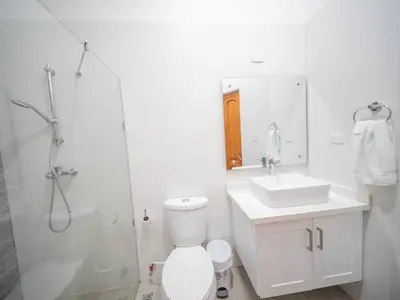 a bathroom with a toilet and a sink and a shower at Villa Selena - 5br Villa In Sosua Center in Sosúa