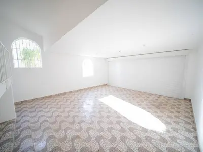an empty room with a white garage door and a window at Villa Selena - 5br Villa In Sosua Center in Sosúa