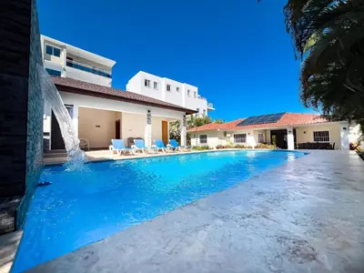 a swimming pool in front of a house at Villa Selena - 5br Villa In Sosua Center in Sosúa