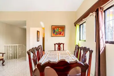 a dining room with a table and chairs at Casa para vacacionar - El patio de Olivia in San Felipe de Puerto Plata