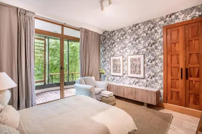 a bedroom with a bed and a chair and a window at Magical apartment with garden view in Casa de Campo in El Infiernito